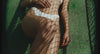 Campaign video of a model reclining on a tennis court, wearing the Tommy Swim Top and Stevie Swim Bottom in Sky Blue with contrasting white binding by Fella Swim.